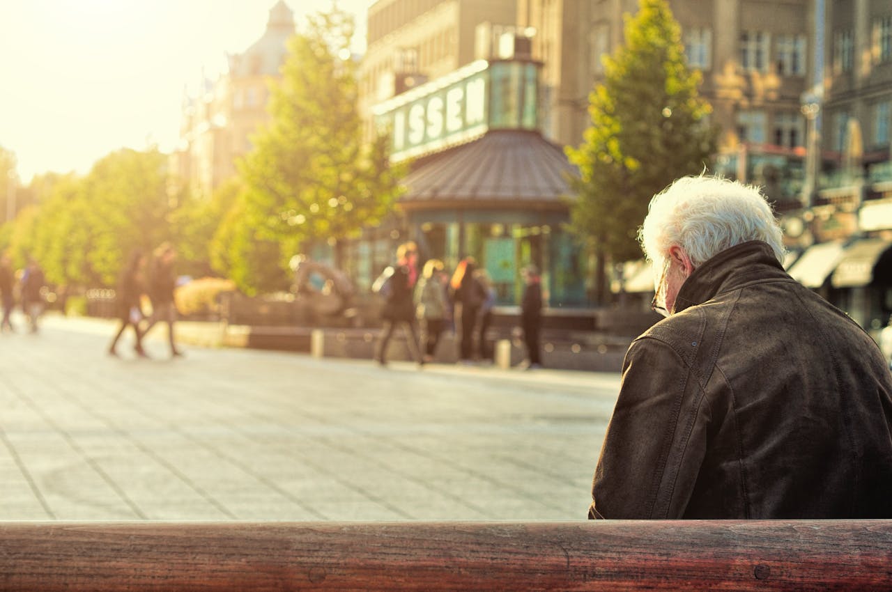 Man Sitting on Wooden Bench