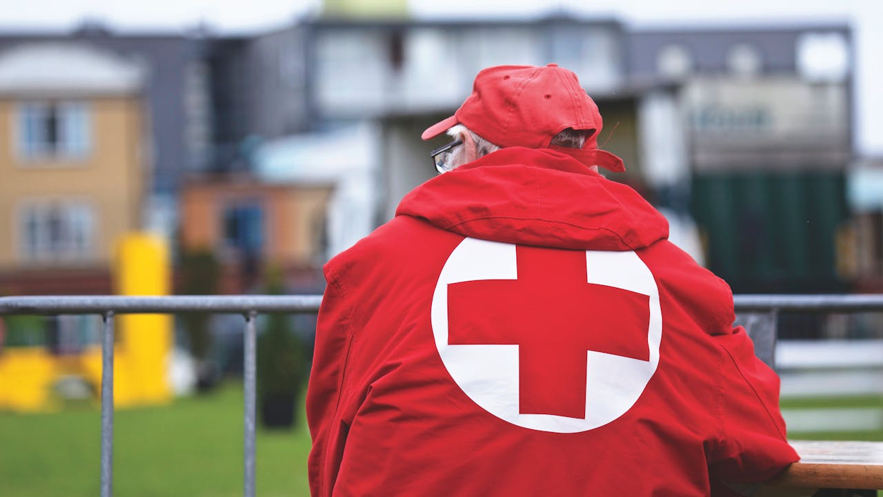 man wearing red cross uniform