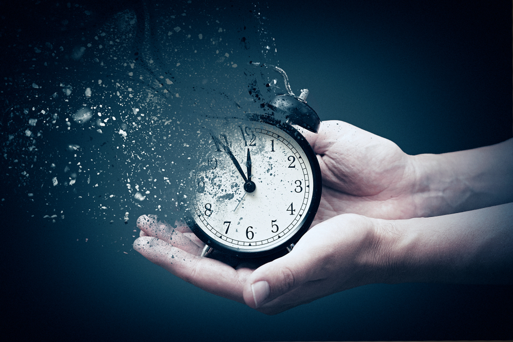 Person holding analog clock with dispersion effect