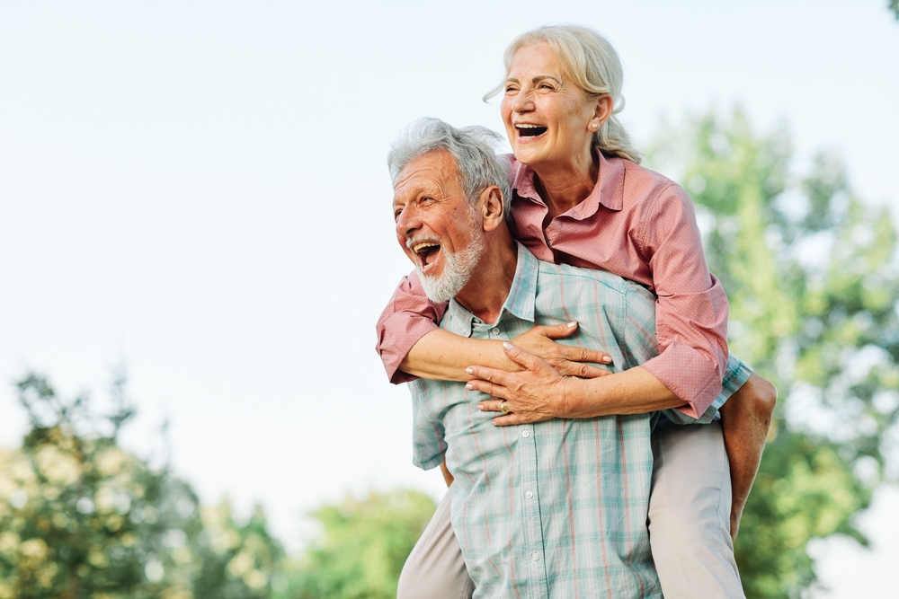 Happy active senior couple having fun outdoors