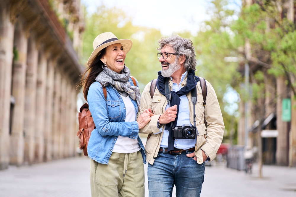 Happy older couple having fun walking outdoors in city