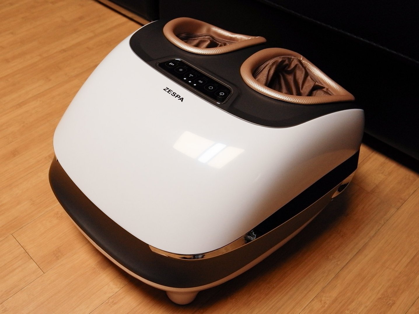 Close Up Photo of White Foot Massager placed on a wooden floor
