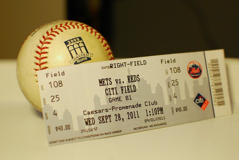 Close Up Photo of Baseball ticket and ball
