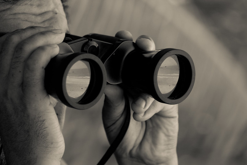 Close Up Photo of of person with binoculars