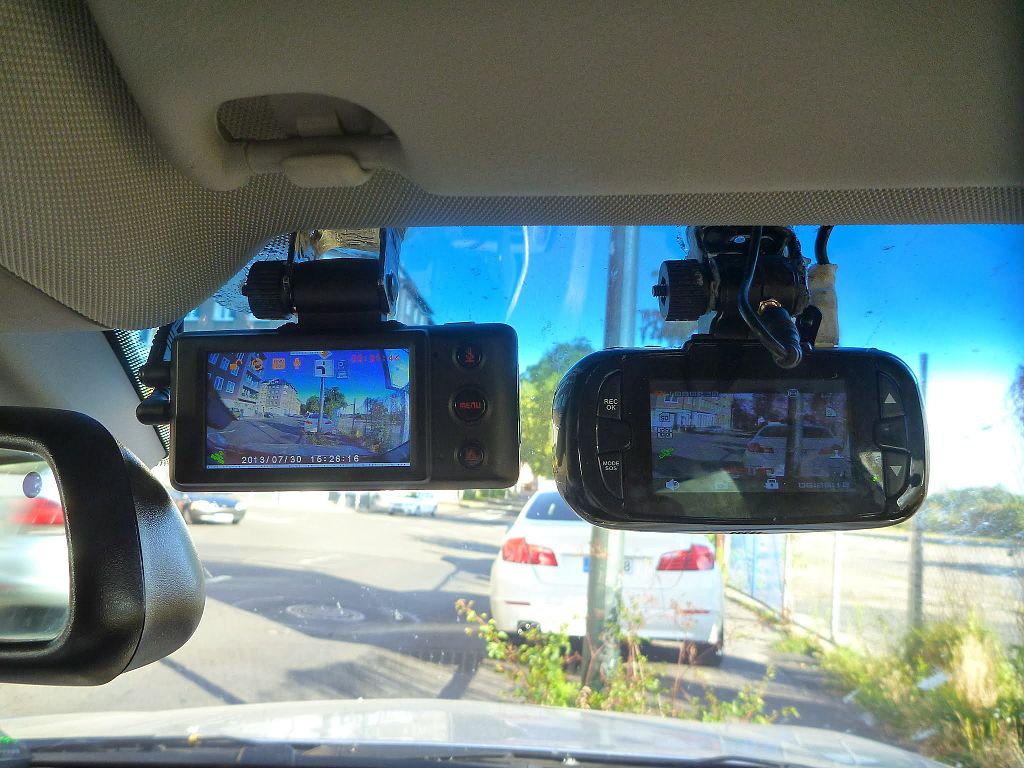 Close Up Photo of Dashcams placed on a car windshield.