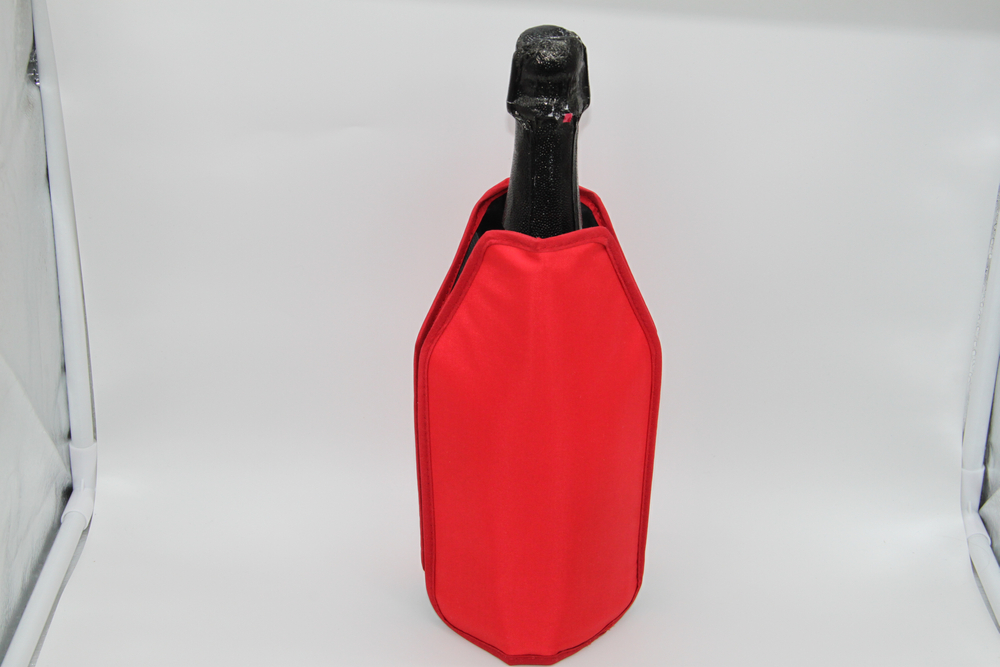Close Up Photo of red sleeve to keep a bottle of champagne cold