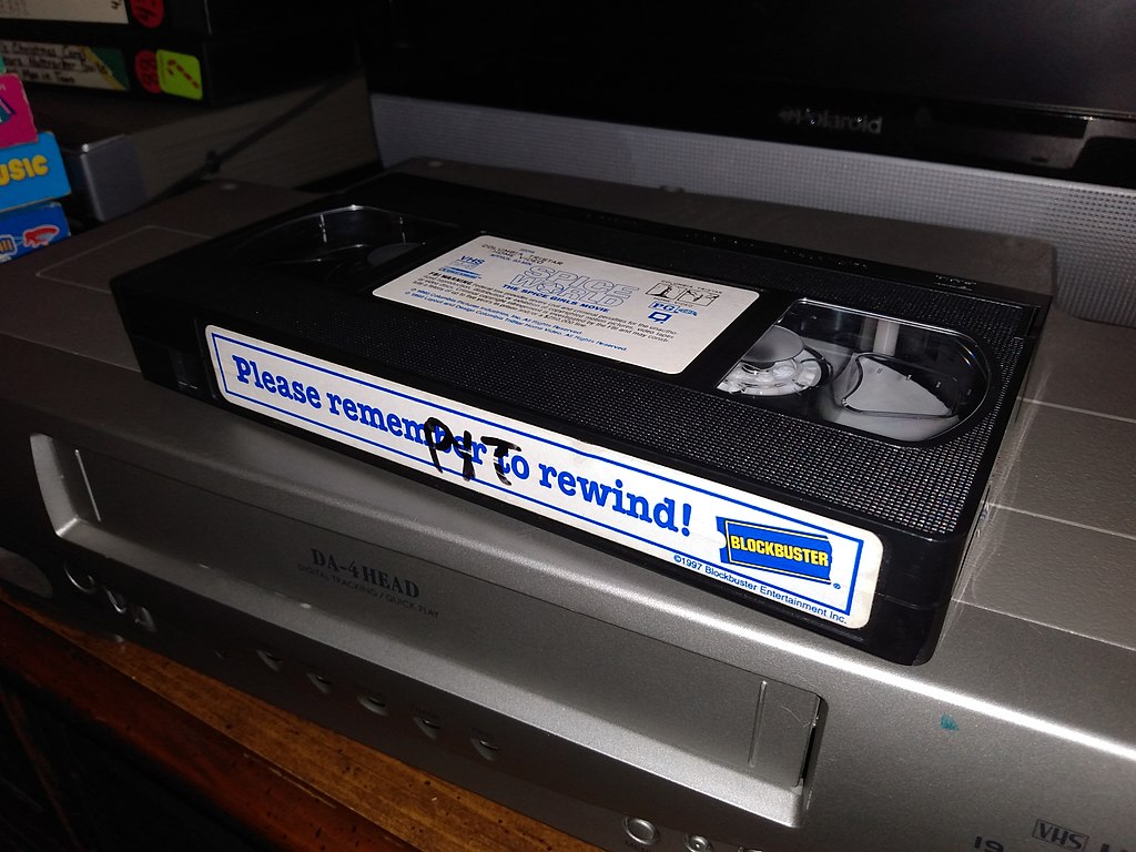 Close Up Photo of Blockbuster VHS Tape placed on a VCR.