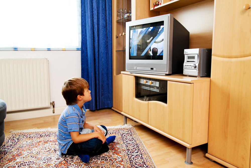 A small child watching television.