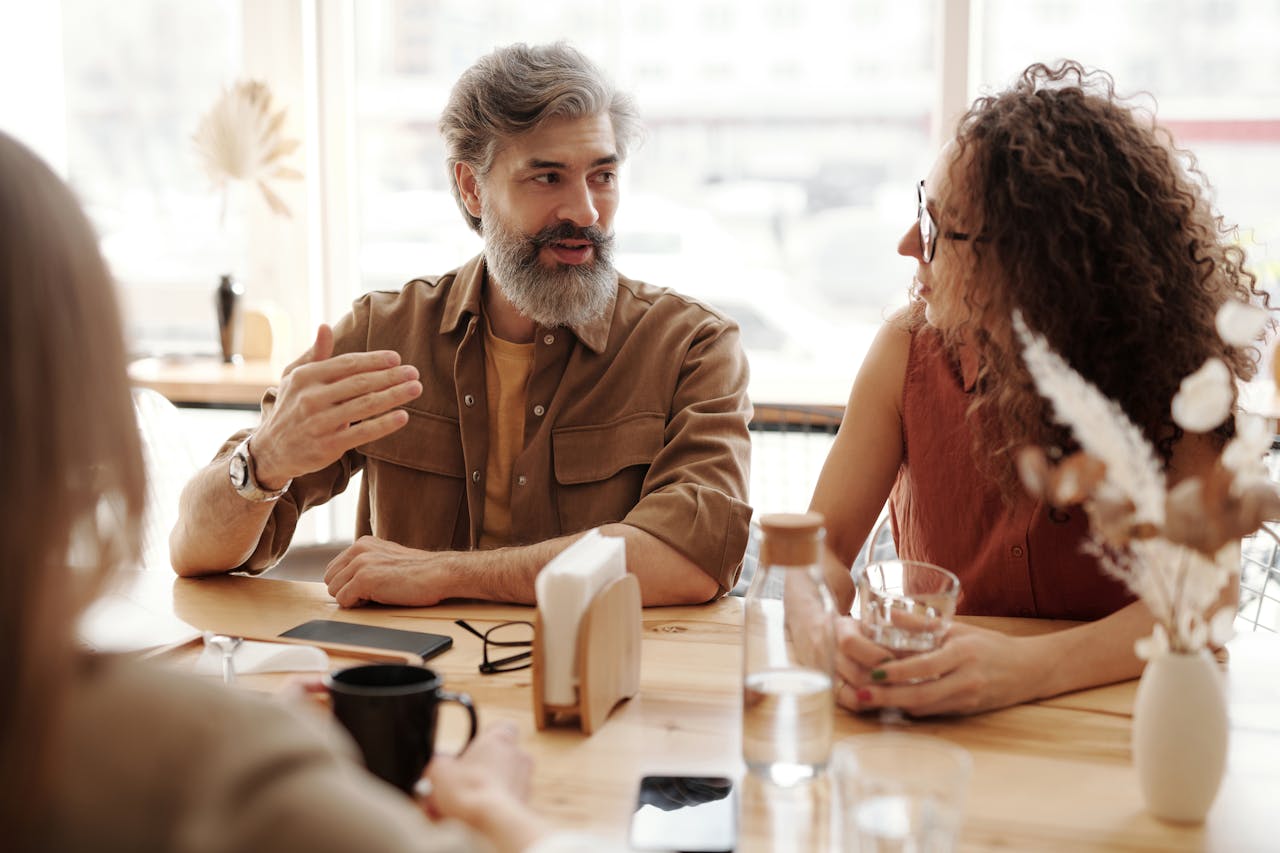 Portrait Photo of A Man and Woman Talking Together