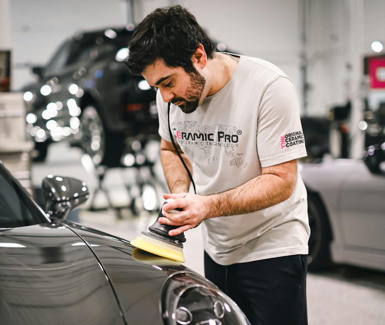 Photo of Man in white t-shirt Polishing Car