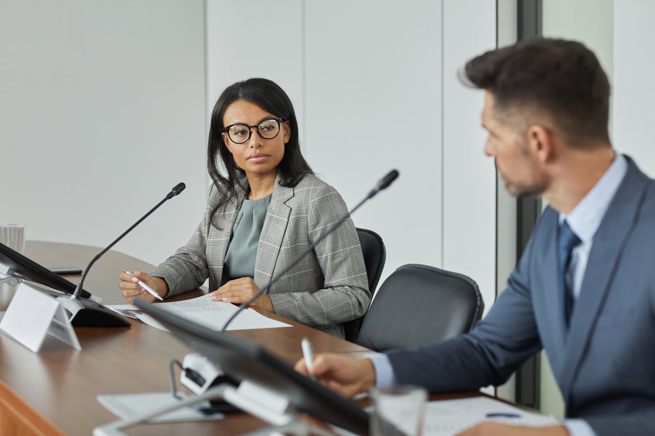 Portrait Photo of Professional Woman looking at Colleague