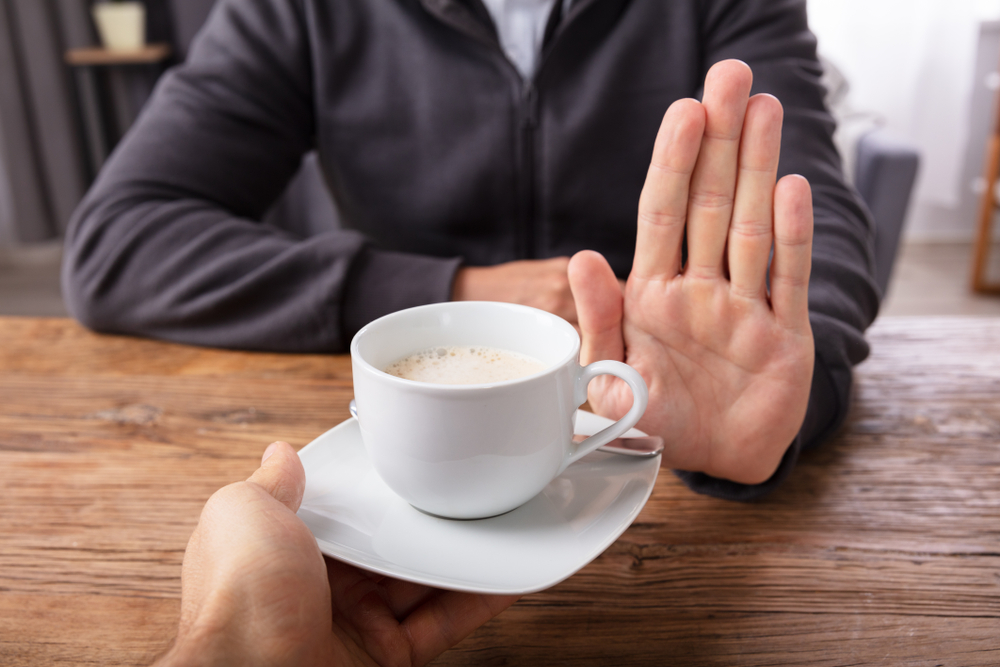 Close-up Of A Man's Hand Refusing Cup Of Coffee