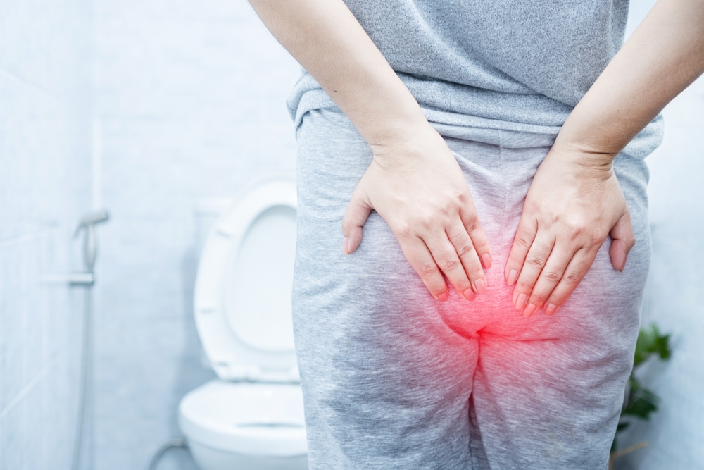 woman suffering from hemorrhoids hurting
