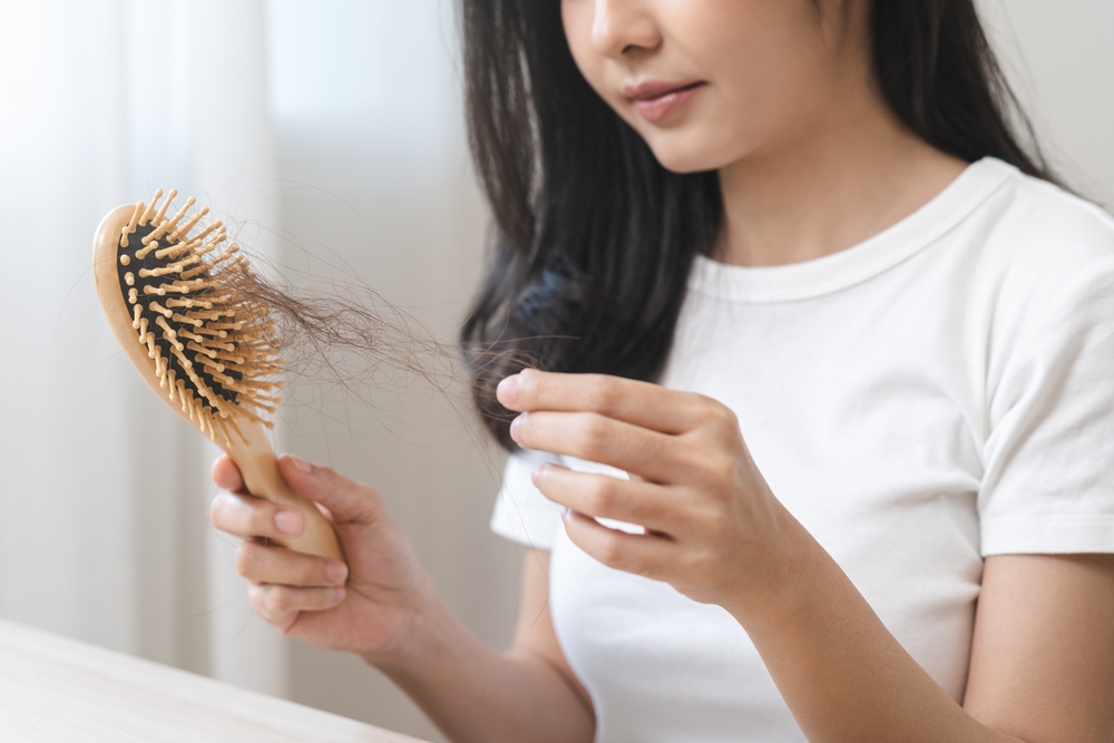 woman holding brush holding comb