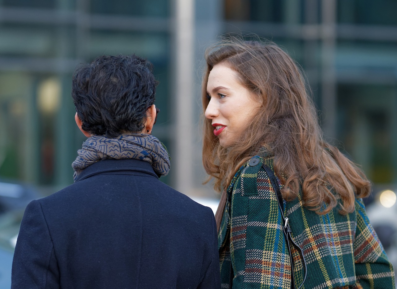 Photo of a Couple Talking while walking