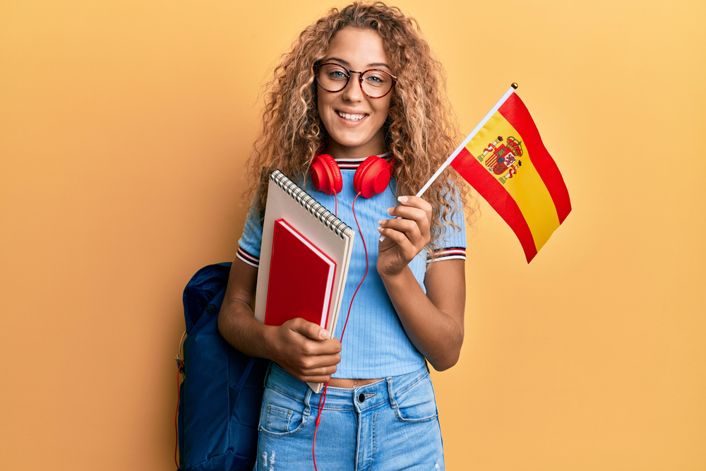 teenager girl exchange student holding Spanish flag