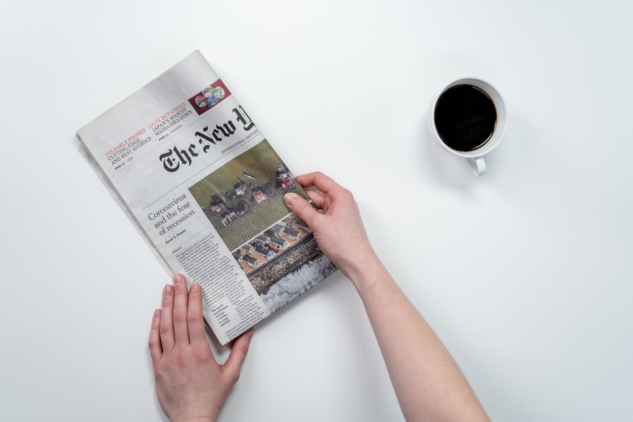 image of a woman holding newspaper