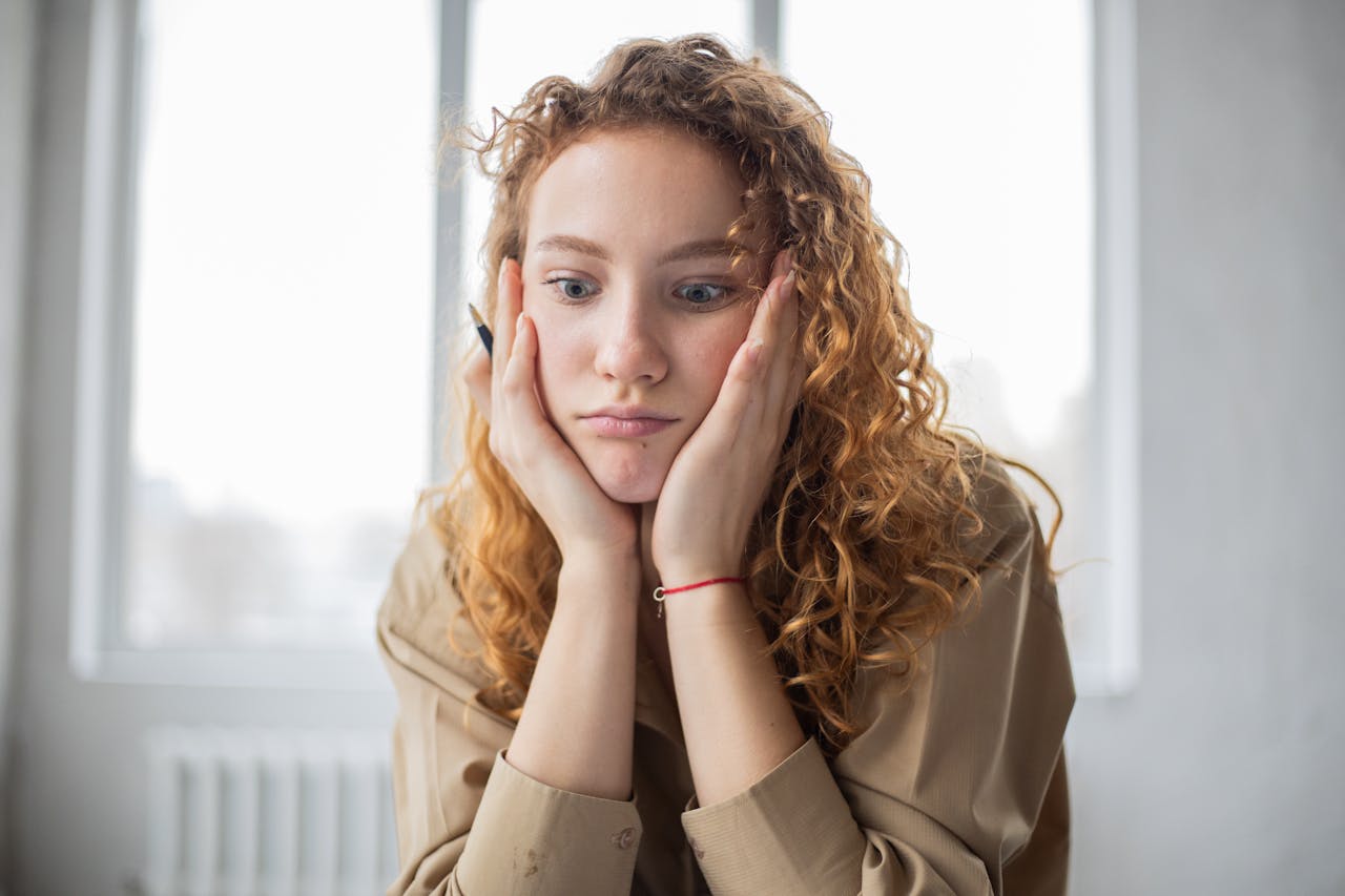 image of a confused girl with pencil in her hand