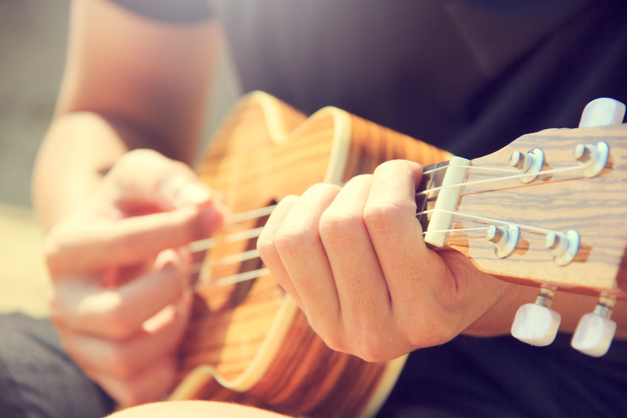 image of a man playing on guitar