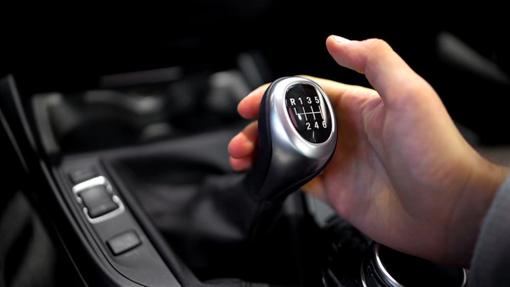 image of Male hand holding manual gearbox
