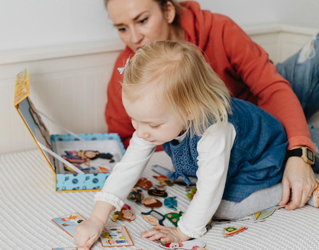 Girl Playing on the Bed with her Mother