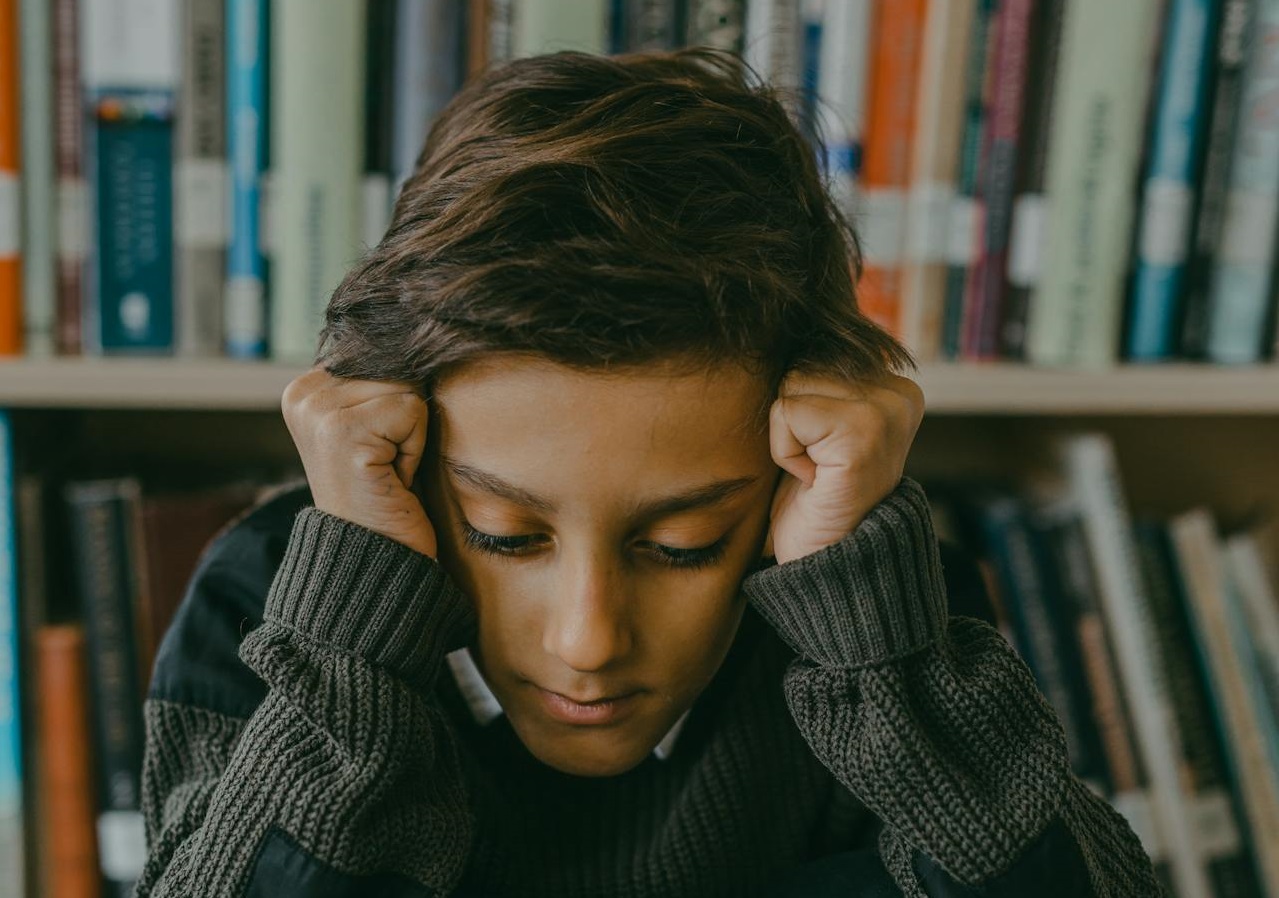 A Stressed Boy Sitting on the Floor