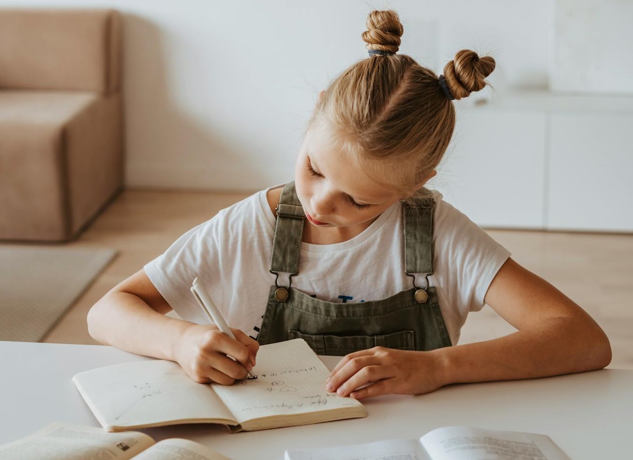 Little Girl Writing on a Notebook