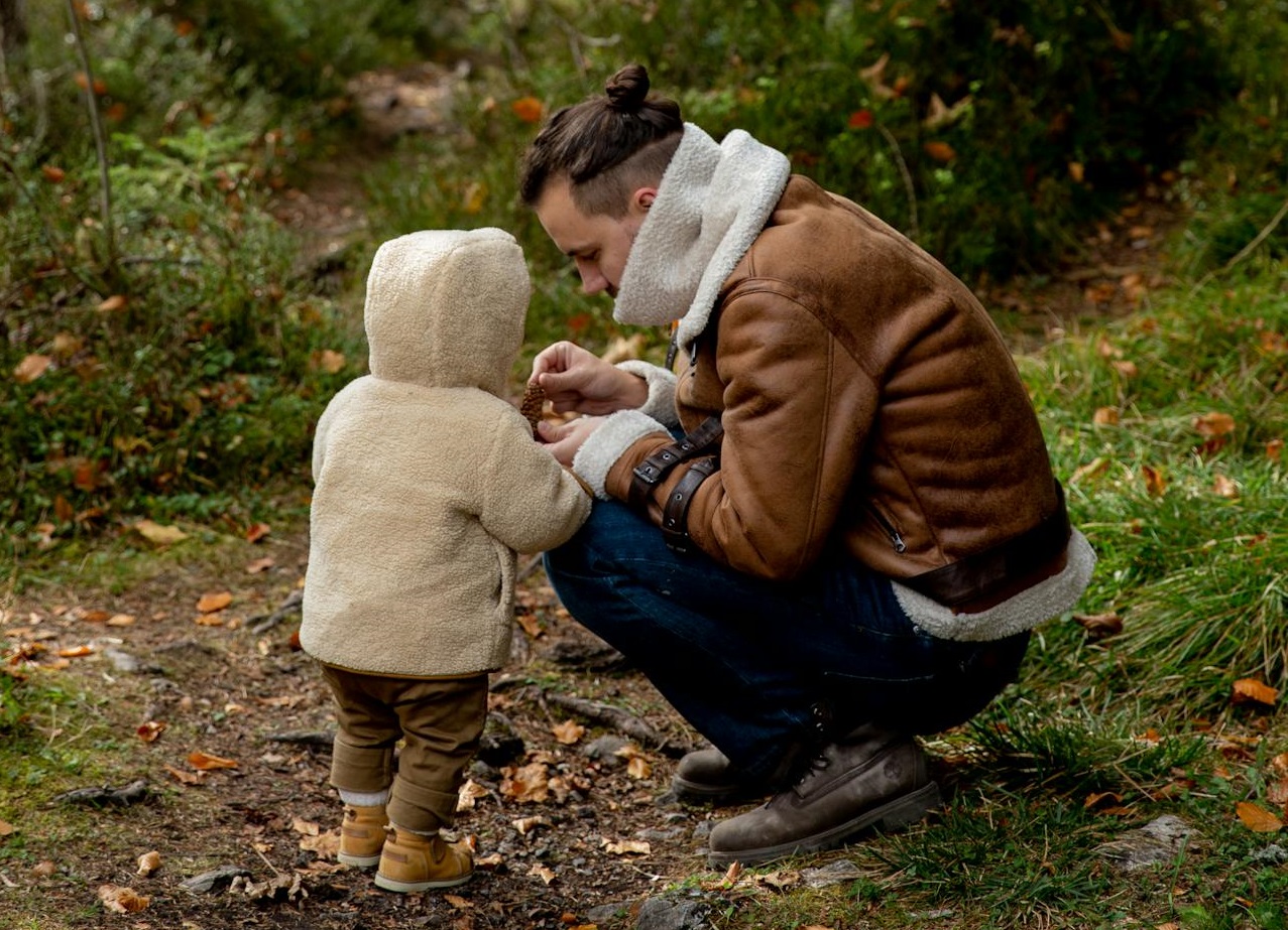 Father and son walking in the woods.