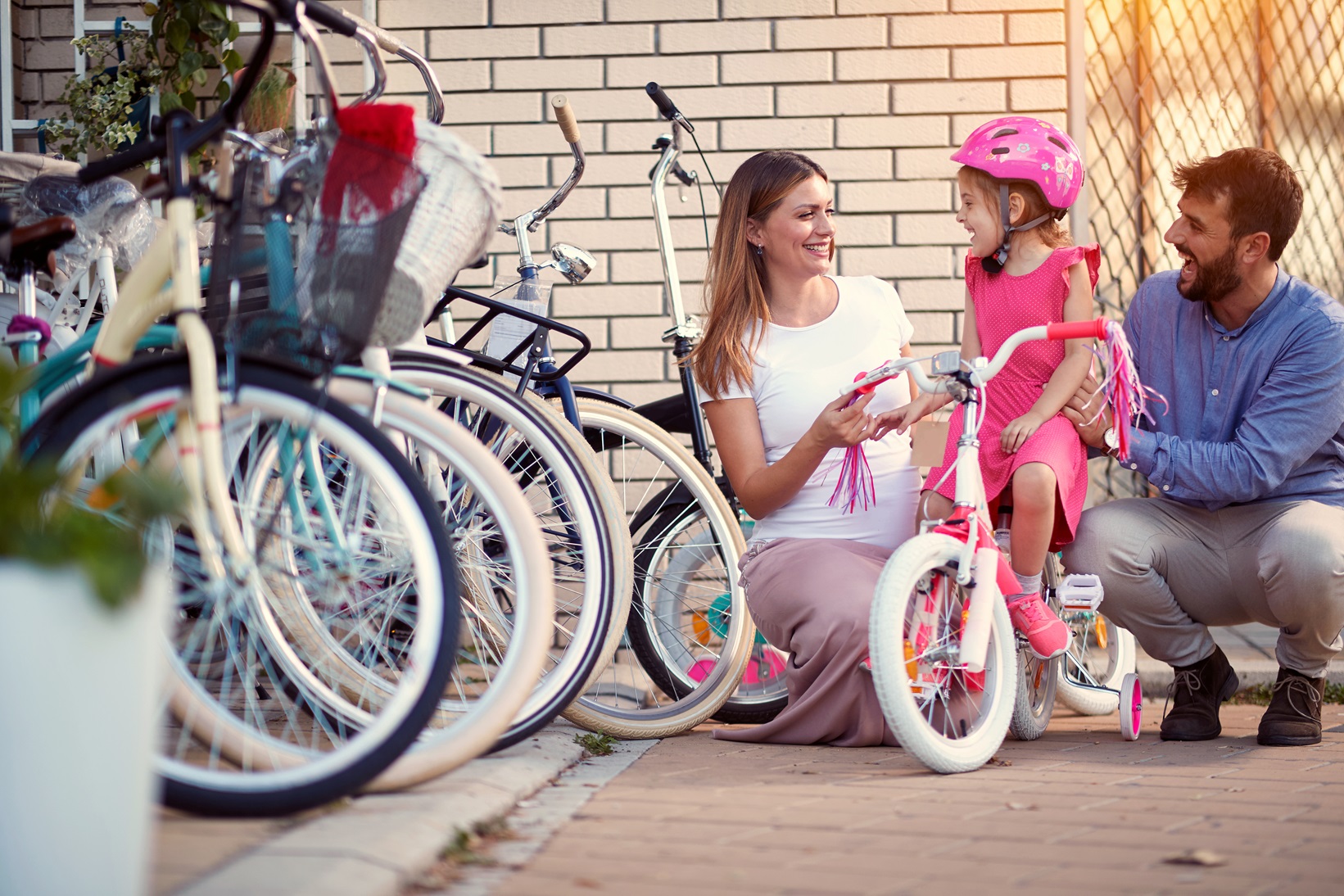 Family with daughter are buying new bicycle at store