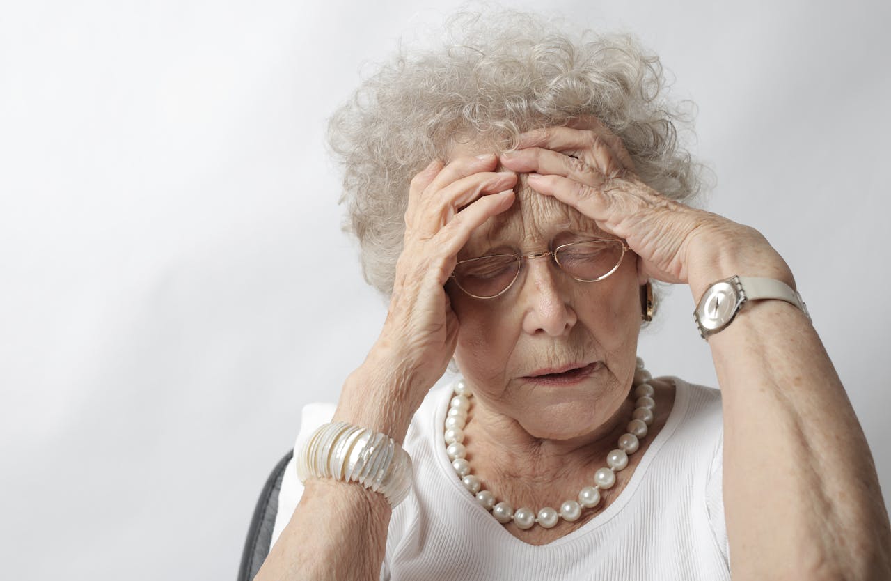 Portrait Photo of a Woman in a white shirt with Headache
