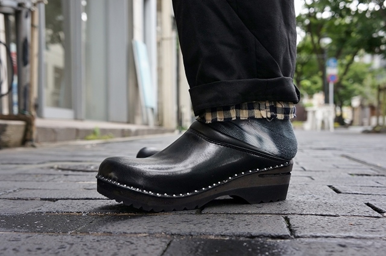 Man wearing black clogs.