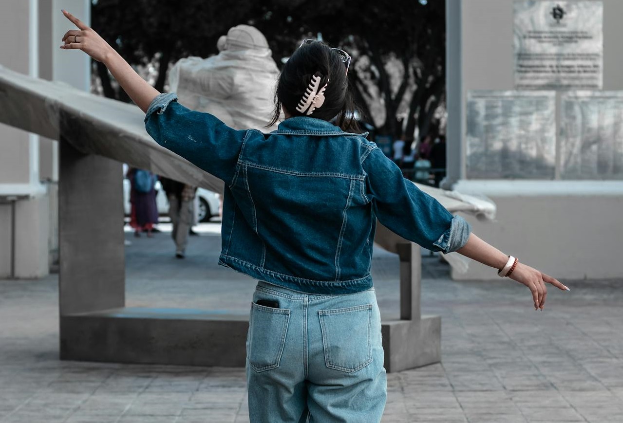 Woman Wearing Denim Jacket and Denim Jeans