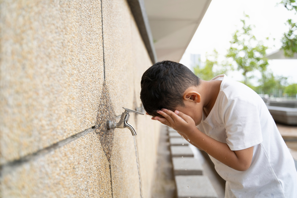 Kid takes ablution before perform a prayer