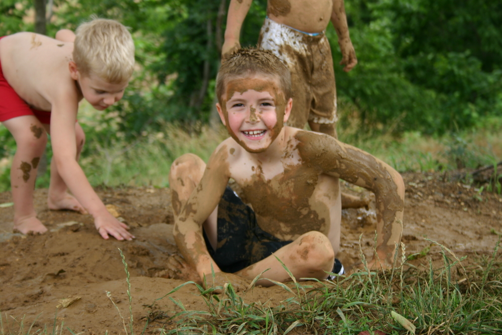 Boy painted with mud