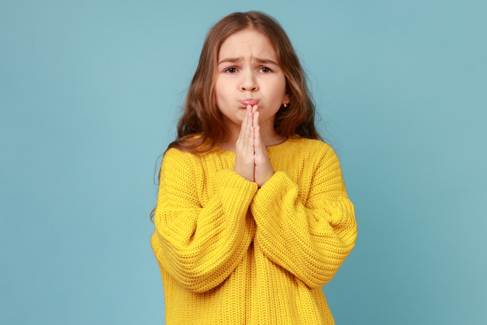 Portrait of little girl praying