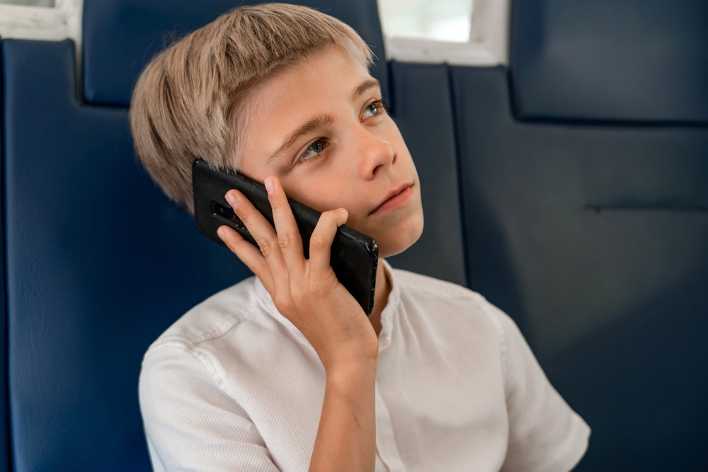 boy sitting talking on phone