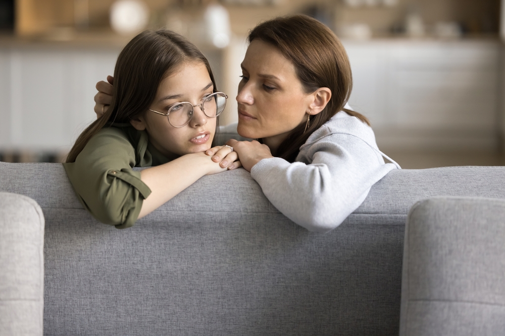 Serious empathetic mom listening to sad frustrated teenage daughter