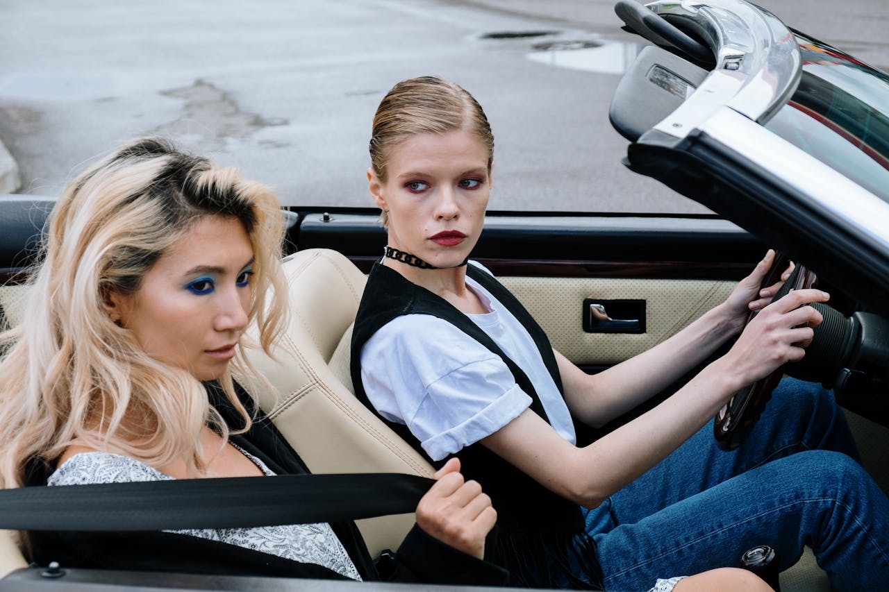 Close Up Photo of Women Inside a Convertible Car