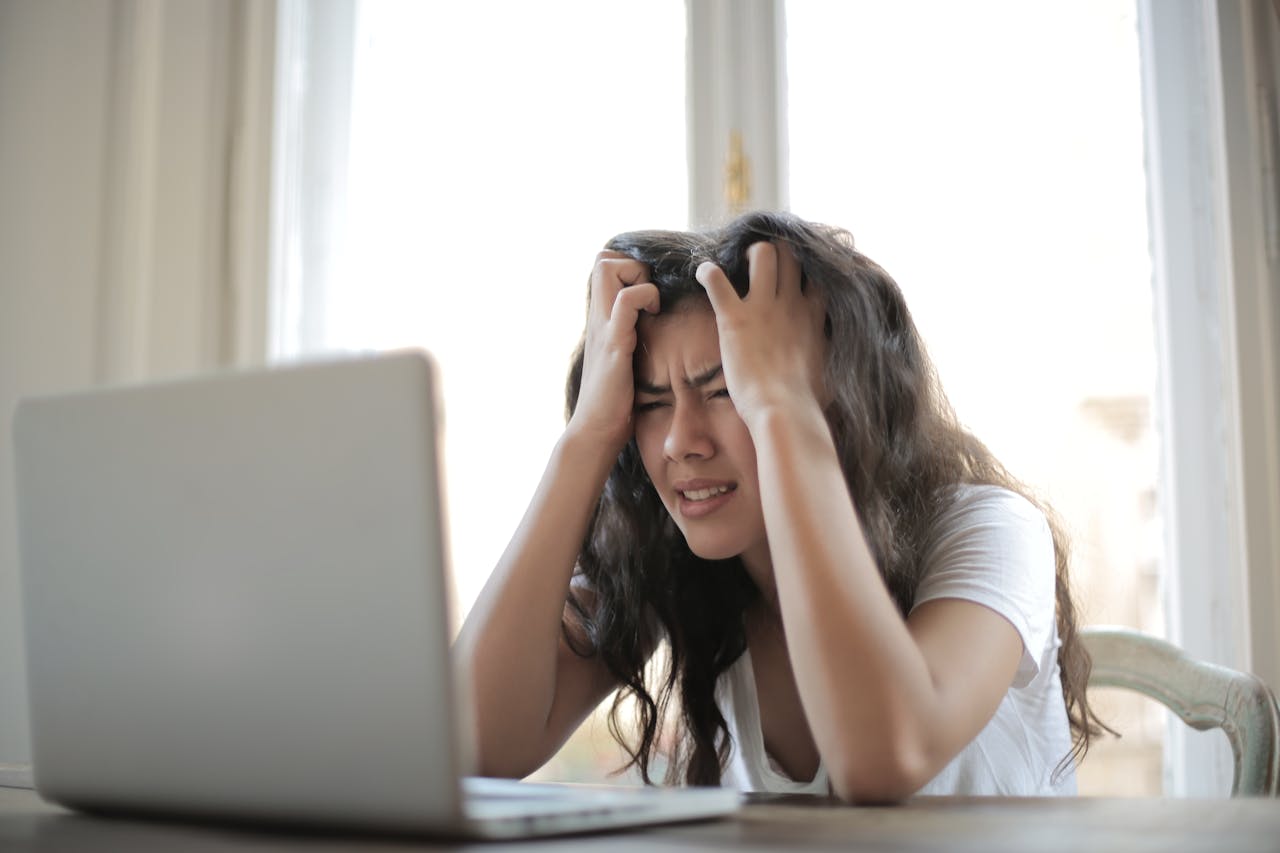Photo of Woman in White Shirt Showing Frustration