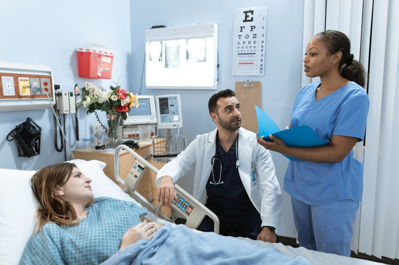 Photo of a Doctor talking to a Patient in Hospital Bed