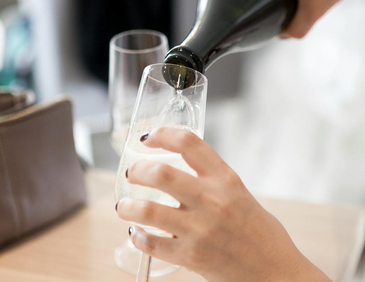 Person About to Pour the Bottle in to Wine Glass