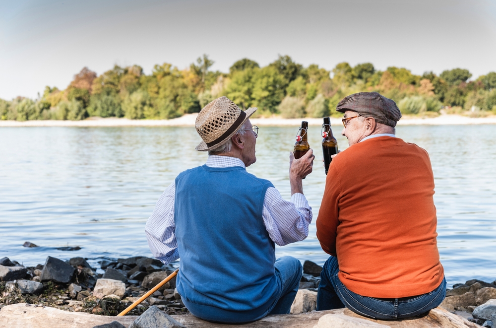 Old friends sitting by the riverside- drinking beer