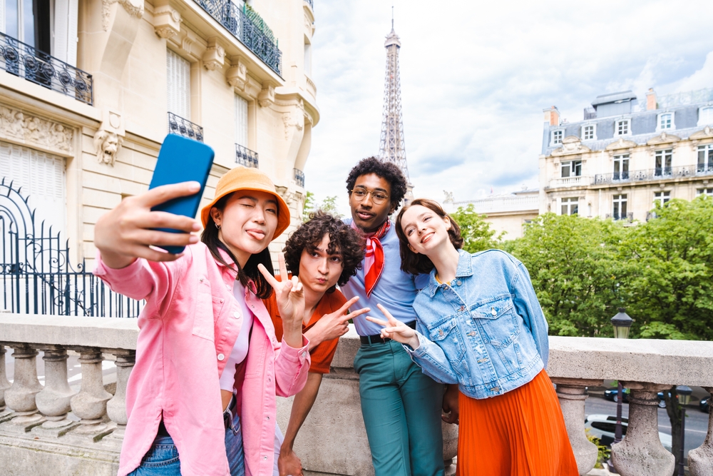 Group of young happy friends visiting Paris