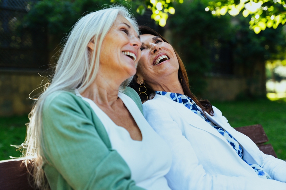 Beautiful senior women bonding outdoors in the city