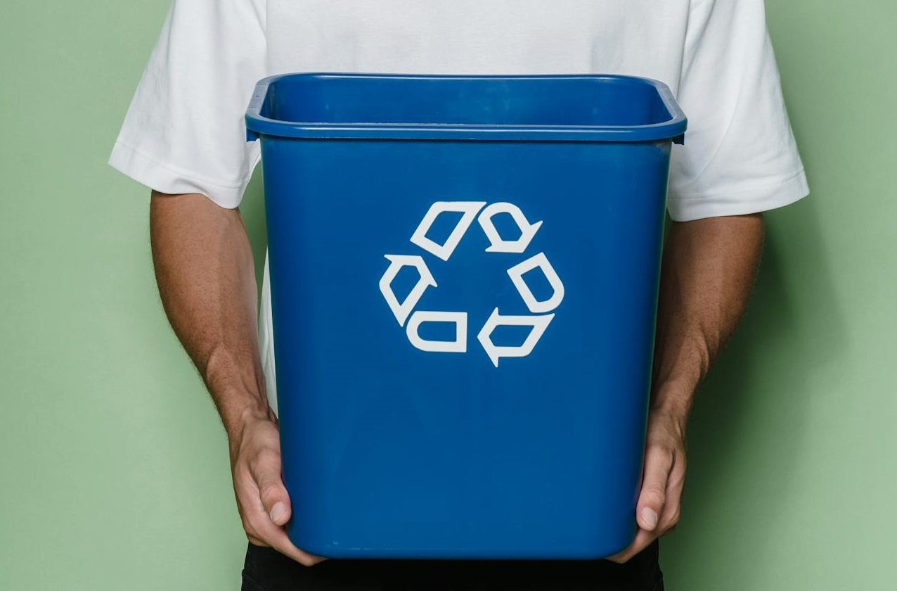 man holding Trash Can