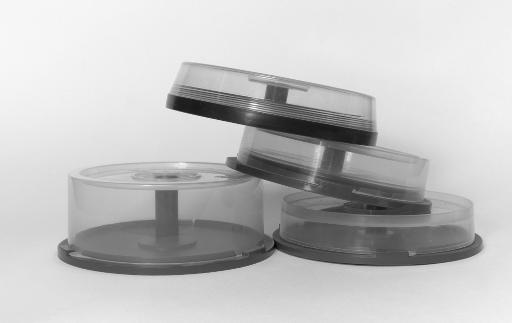 pile of transparent storages with spindel for CDs black and white
