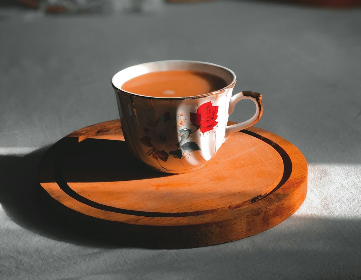 A Cup of Coffee on a Wooden Coaster