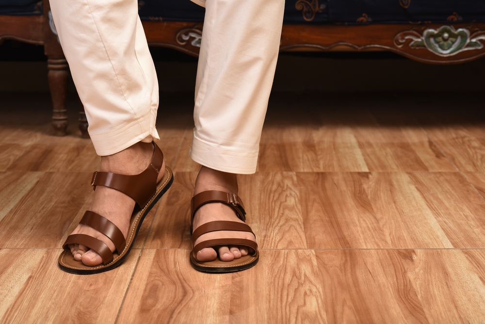 Close up of men foot wearing genuine Sandal leather shoes.