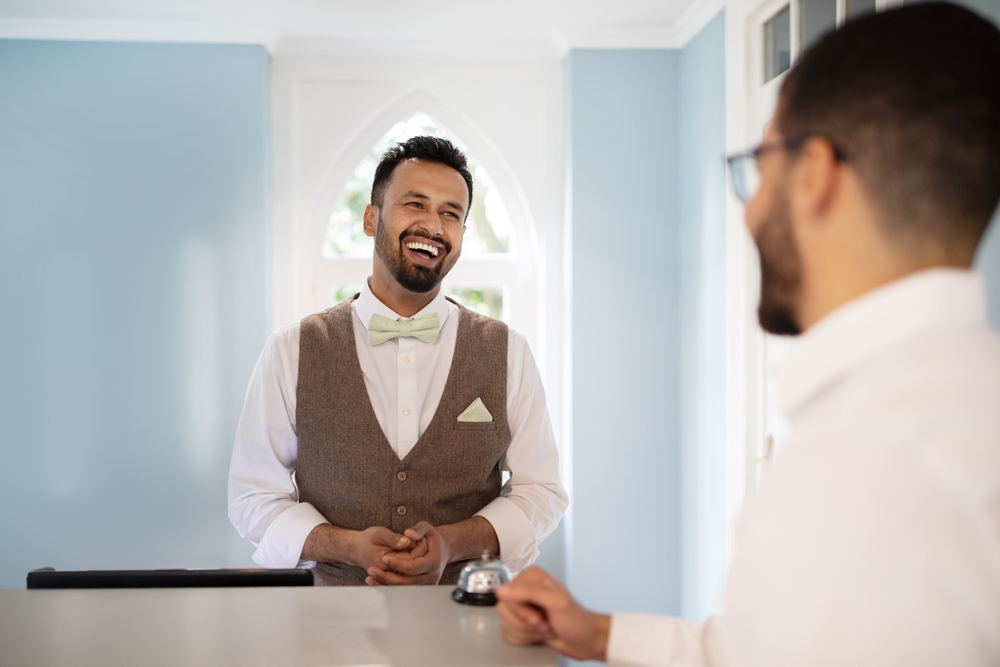 Receptionist Man Laughing Communicating With Businessman Guest