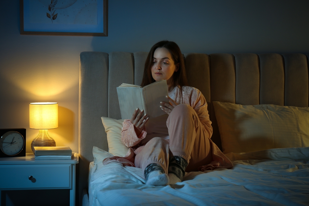 Woman reading before bed